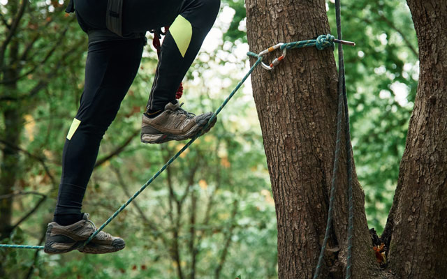 Active person walking on high rope