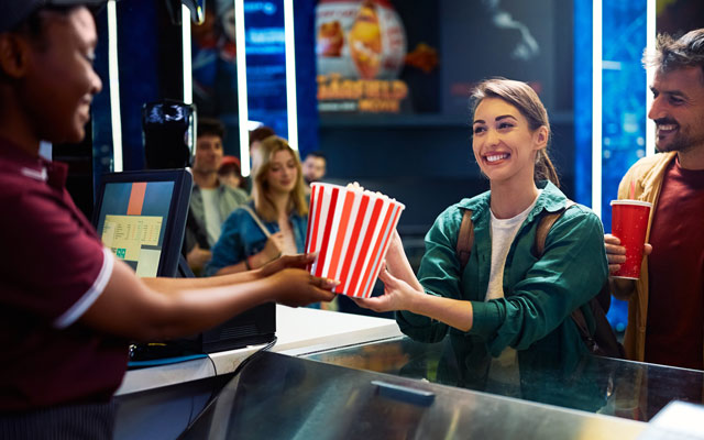 Couple buying popcorn at the cinema