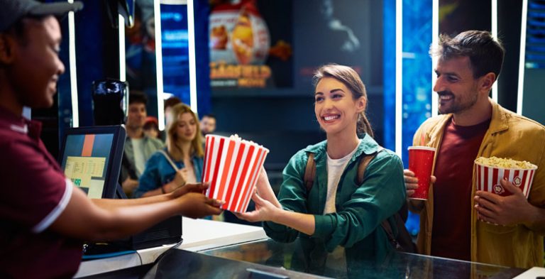 Couple buying popcorn at the cinema