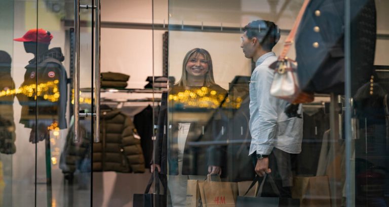 A young couple smiling while shopping